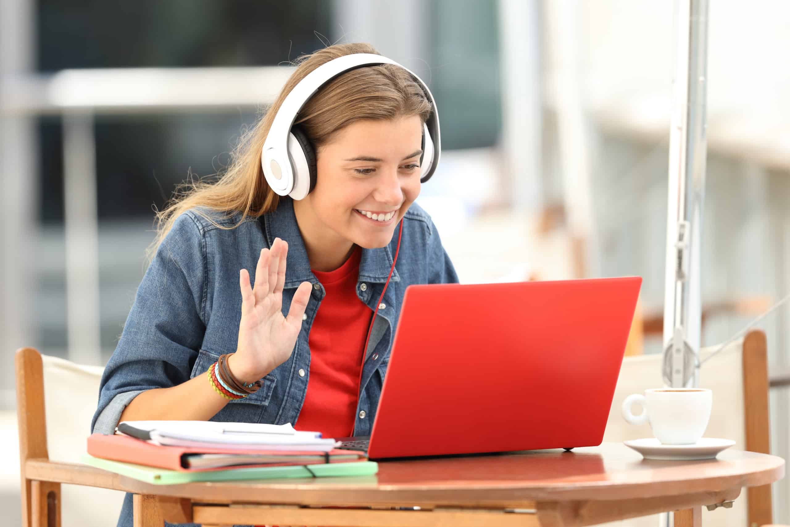 Student with headphones and red laptop