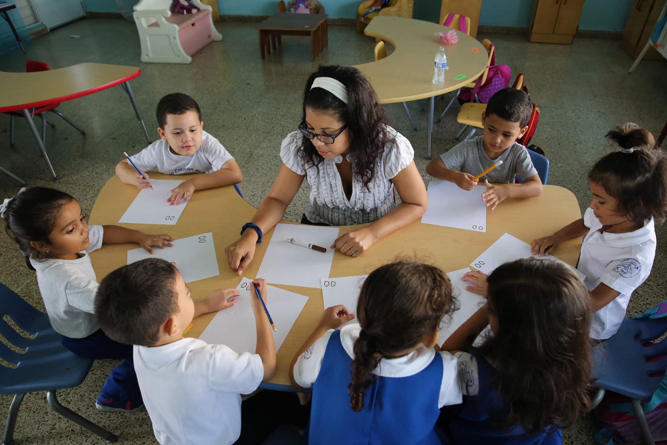 Teacher with her preschool students doing a group activity