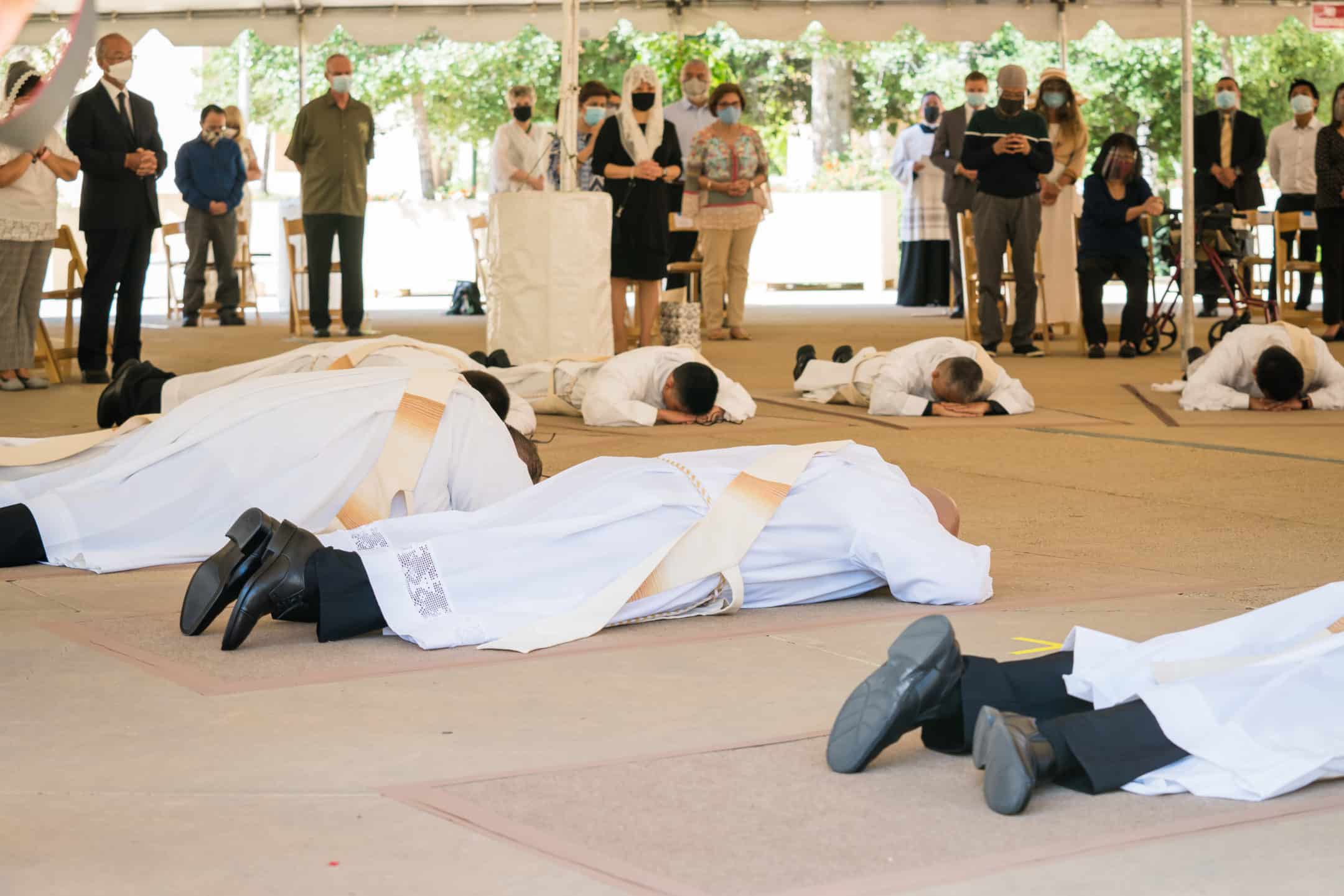 candidates to the priesthood lay prostrate in prayer during the singing of the Litany of the Saints.