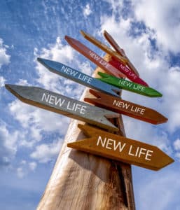 Crossroad signpost with words "New Life"