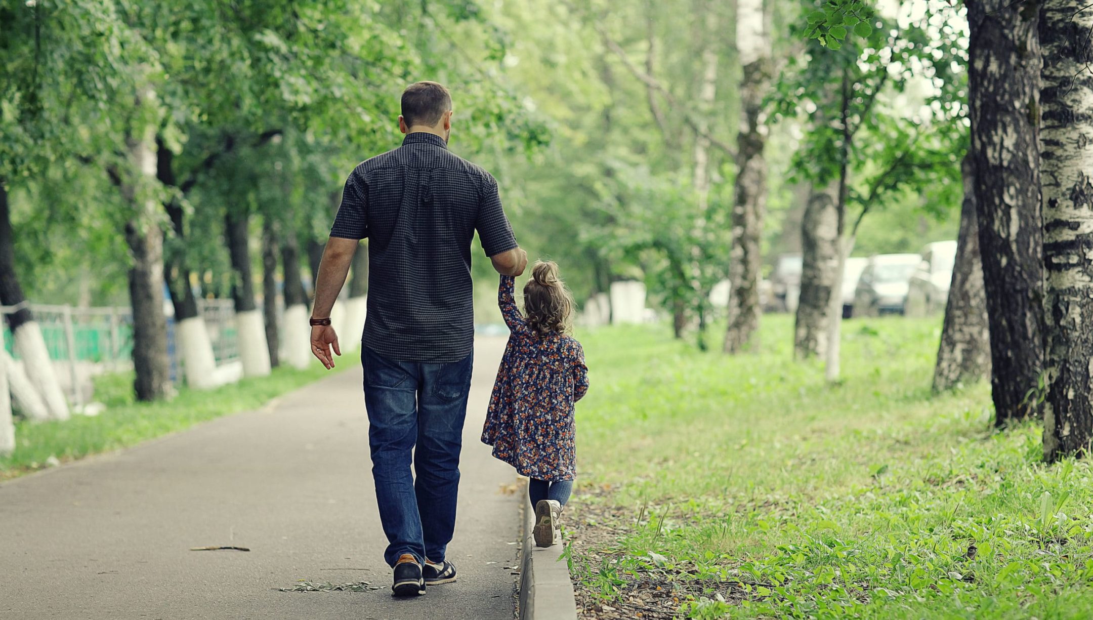 father walking with his daughter in the park