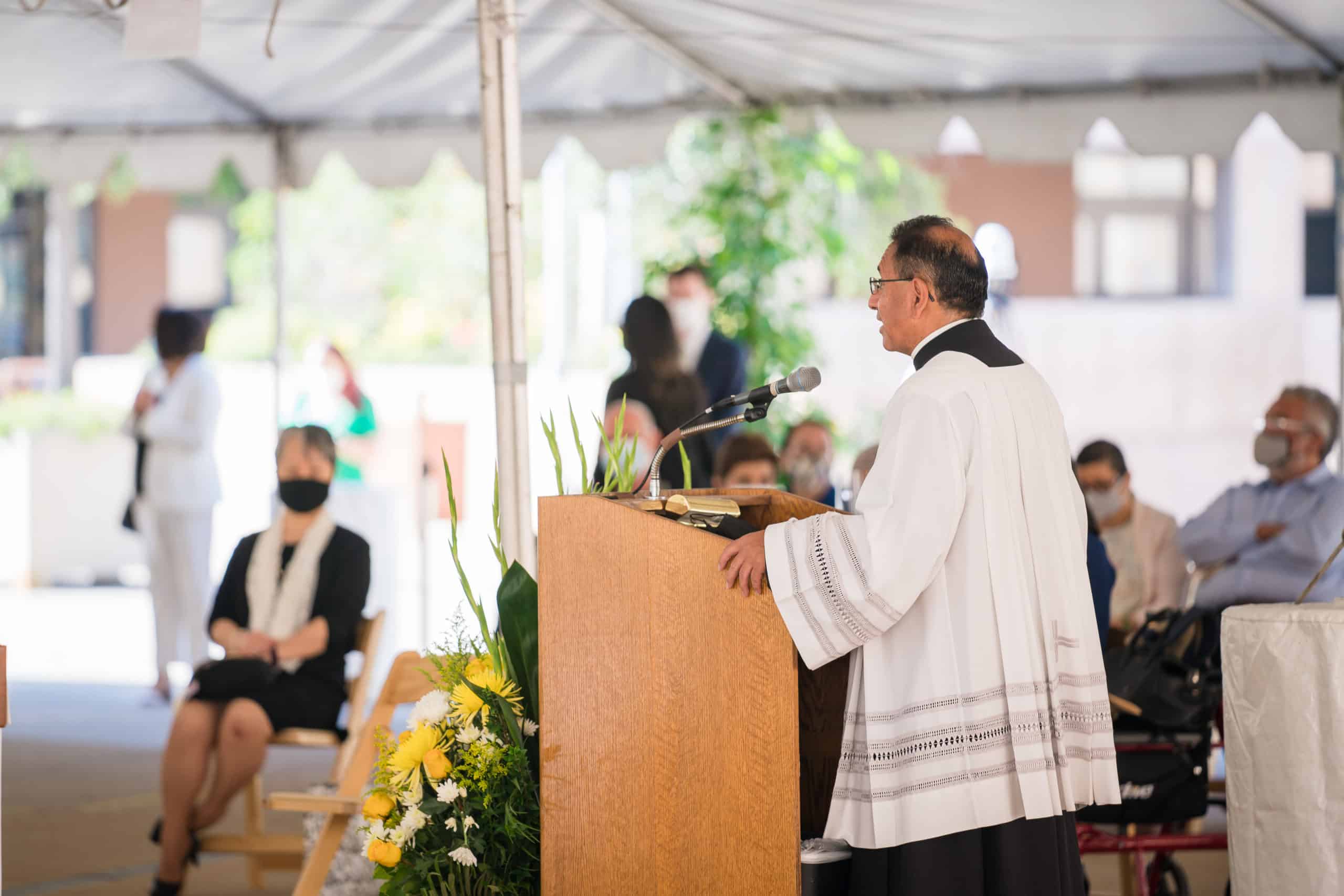 priest presiding an outdoor mass