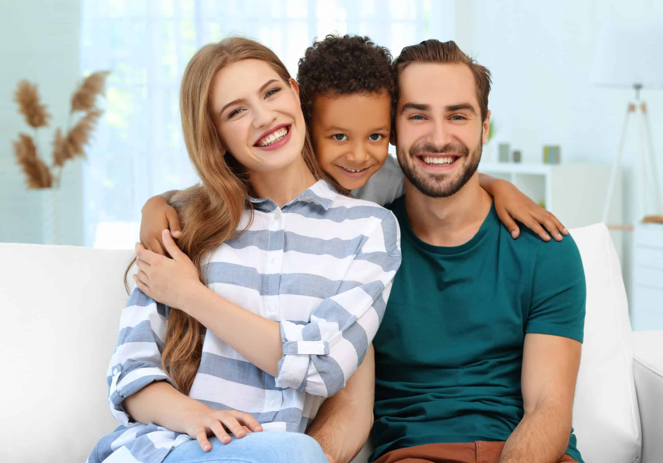 Happy woman and man with adopted son