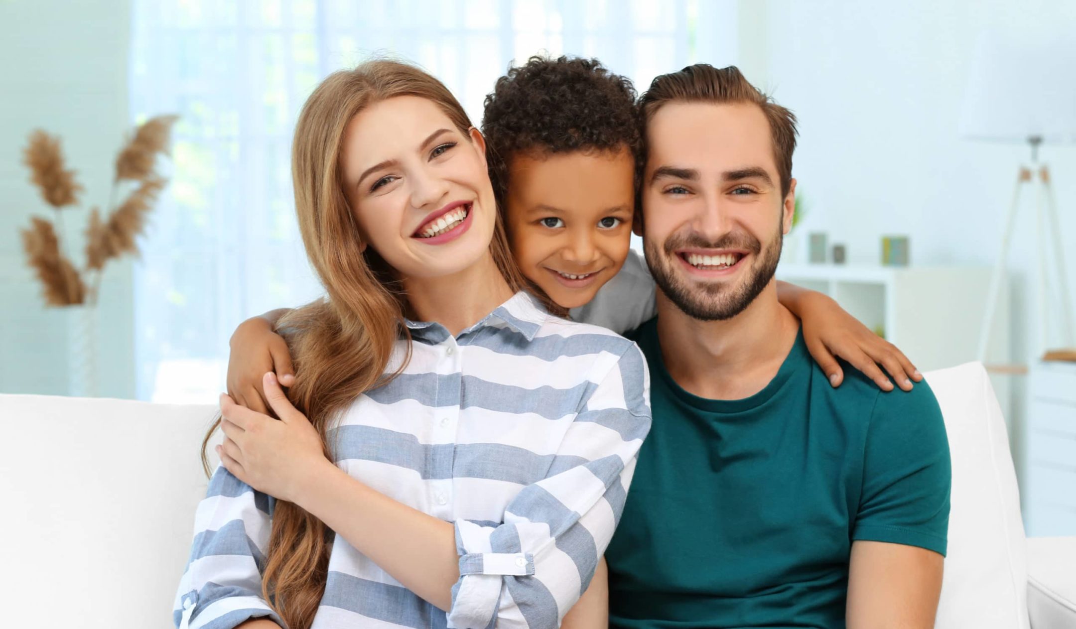 Happy woman and man with adopted son