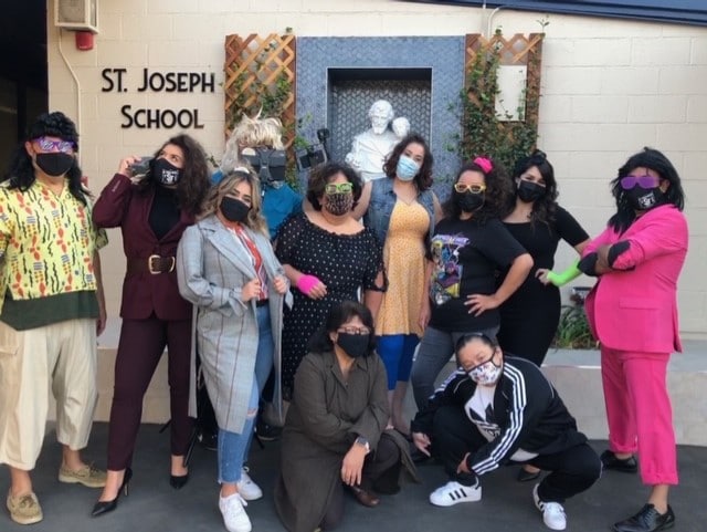 Teachers at St. Joseph School in La Puente pose in their 80s dance costumes after filming a video for students.