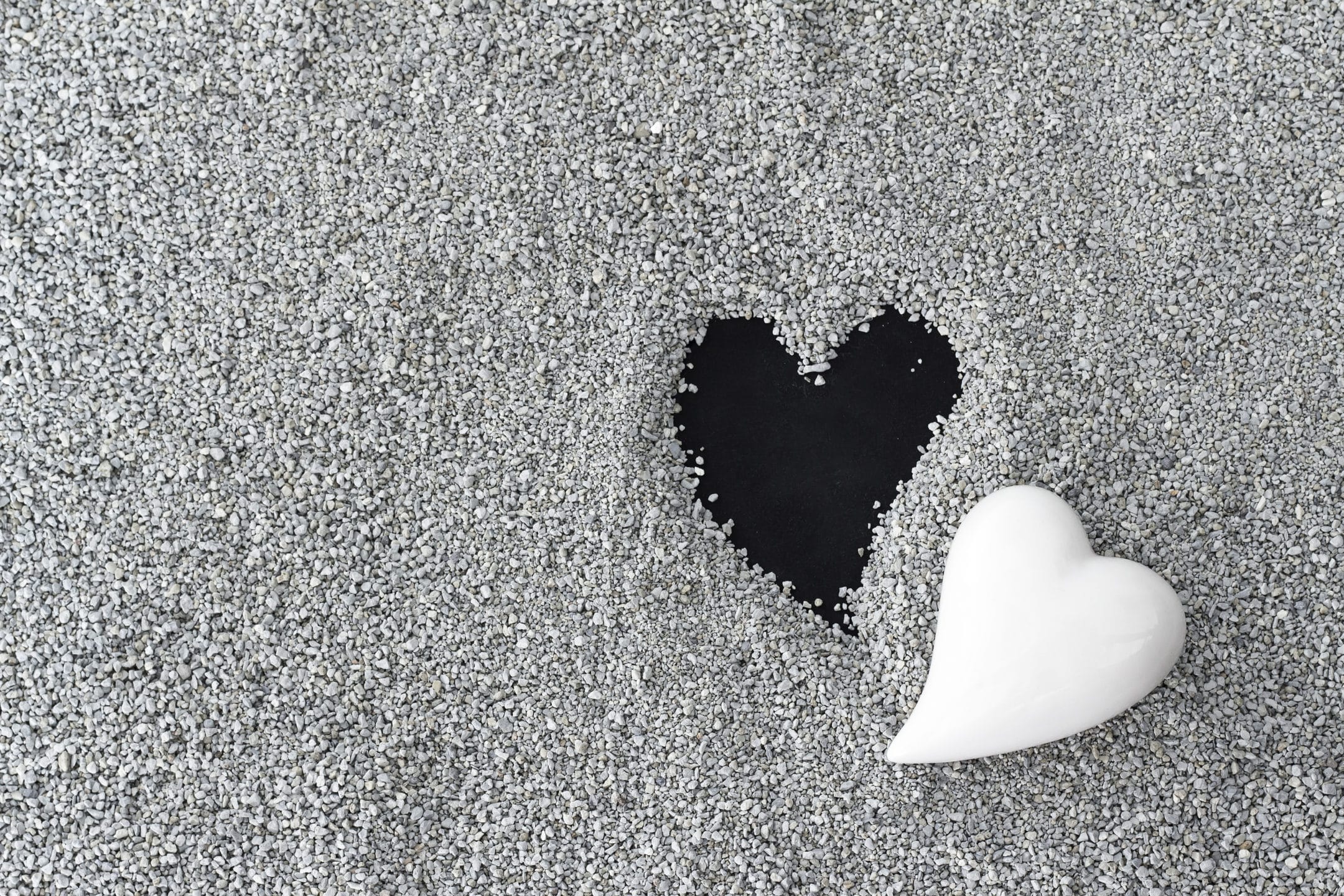 Black and white hearts on the sand