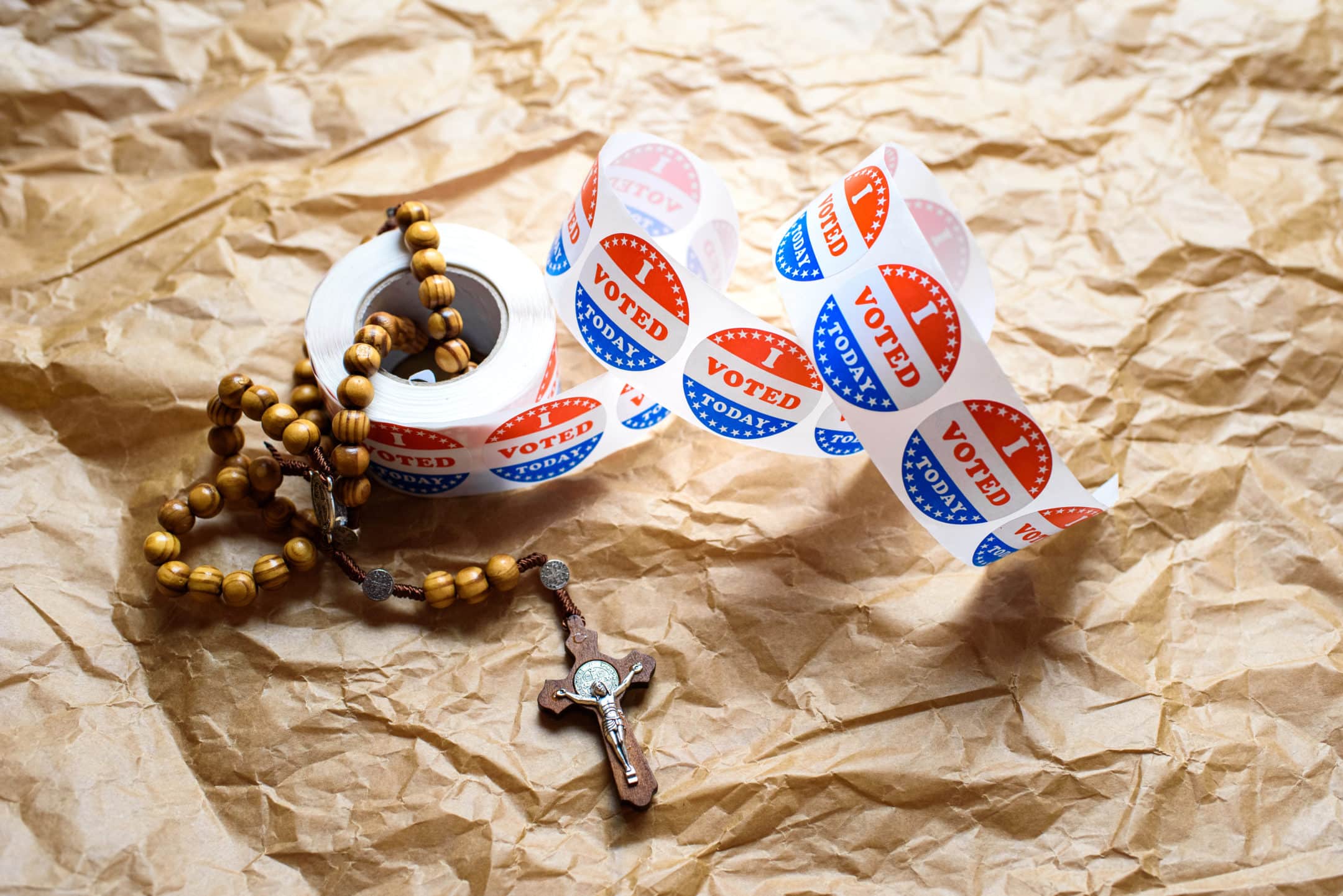 rosary and a roll of I Voted stickers