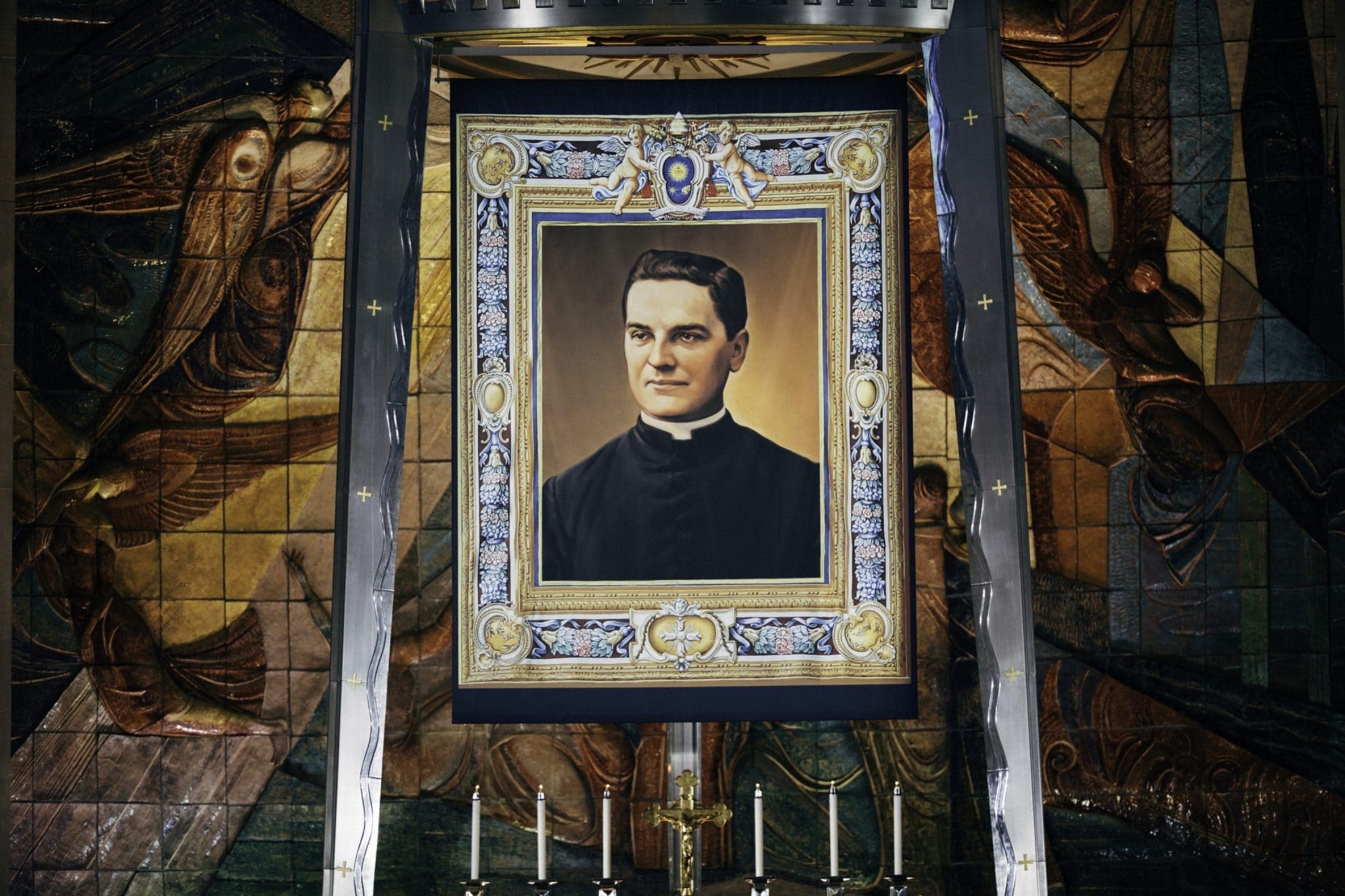 A giant tapestry with a portrait of Bl. Michael McGivney, founder of the Knights of Columbus