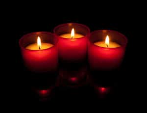 three votive red candles
