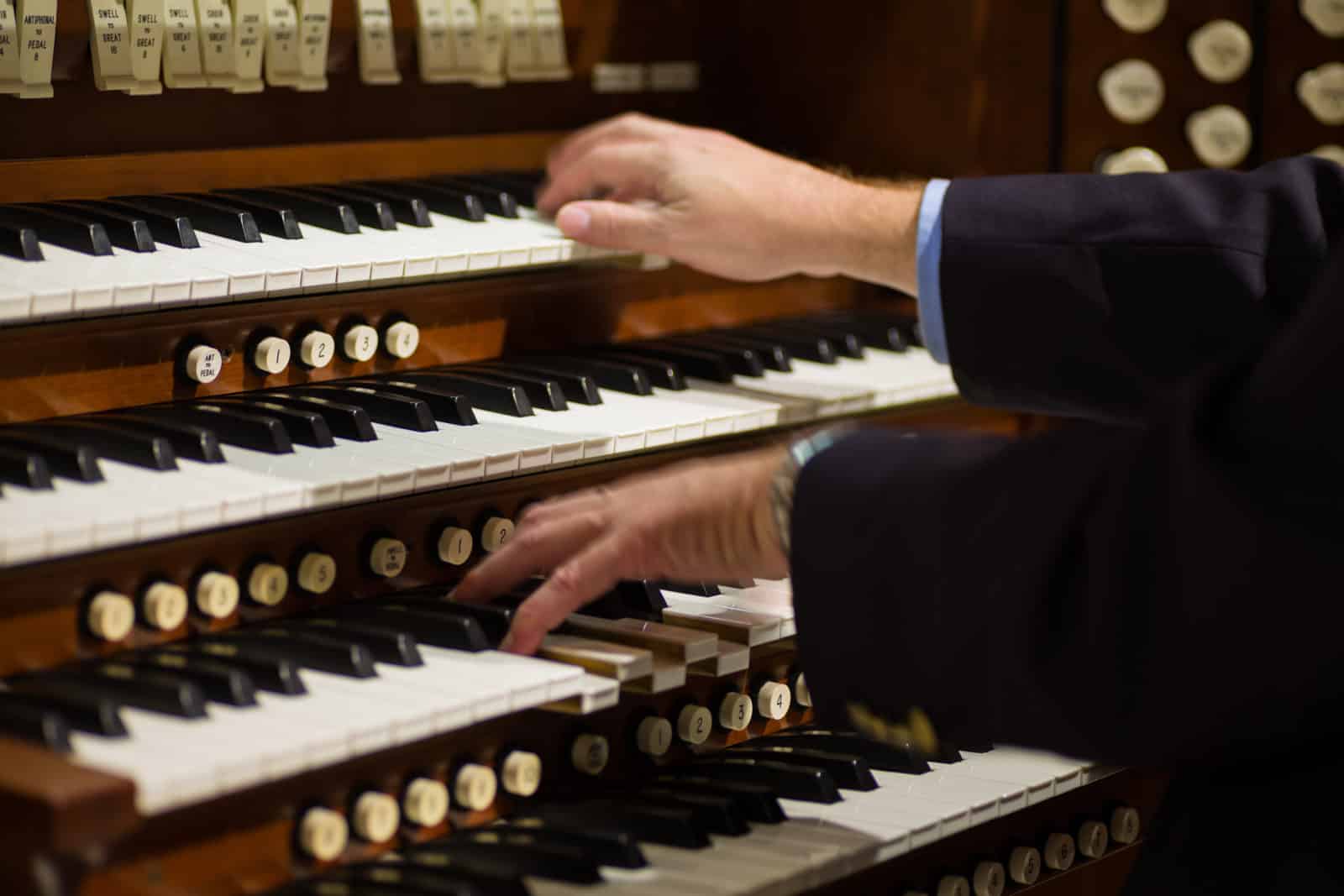organist playing a pipe organ