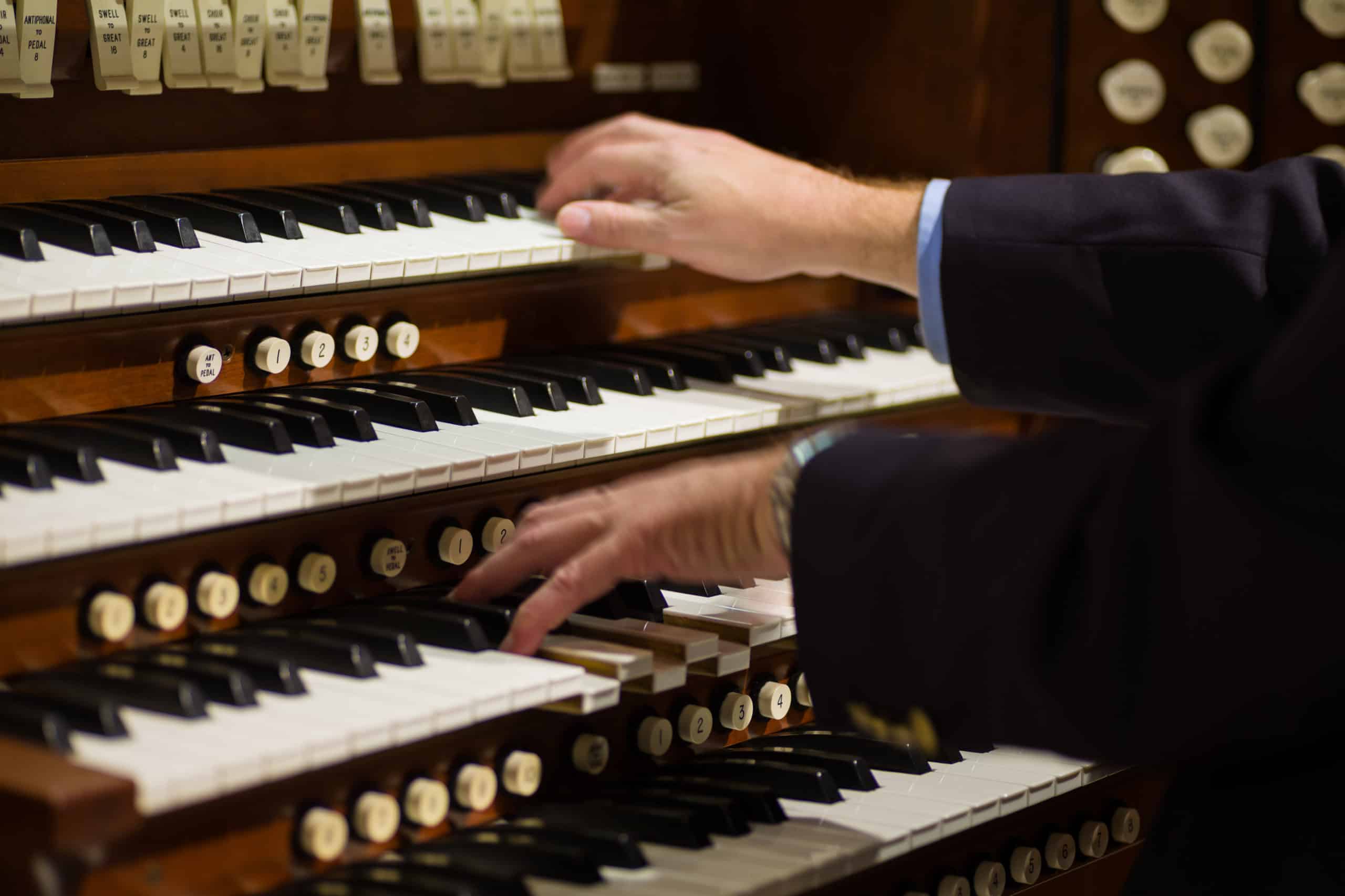organist playing a pipe organ