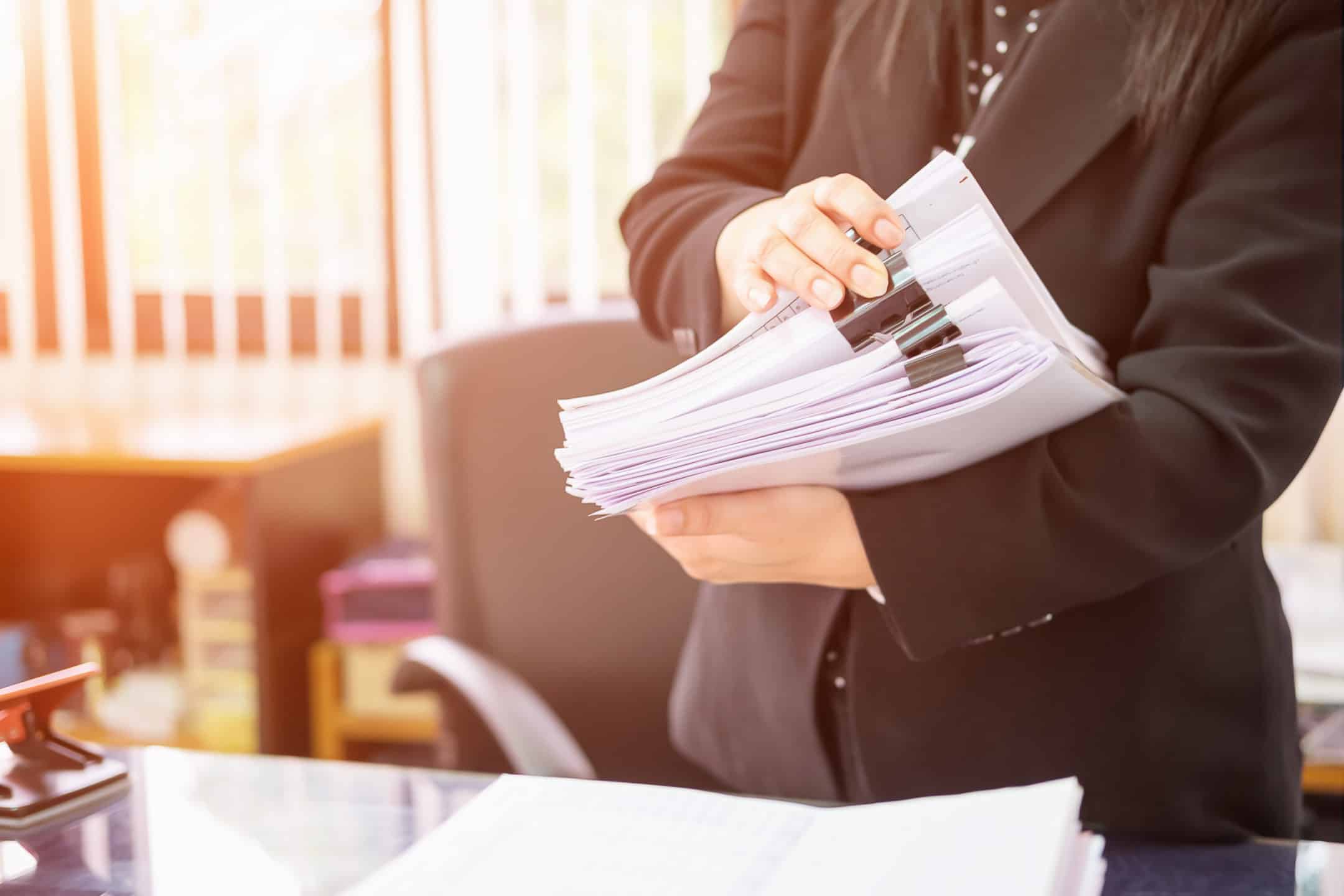 Business Woman holding a stack of documents