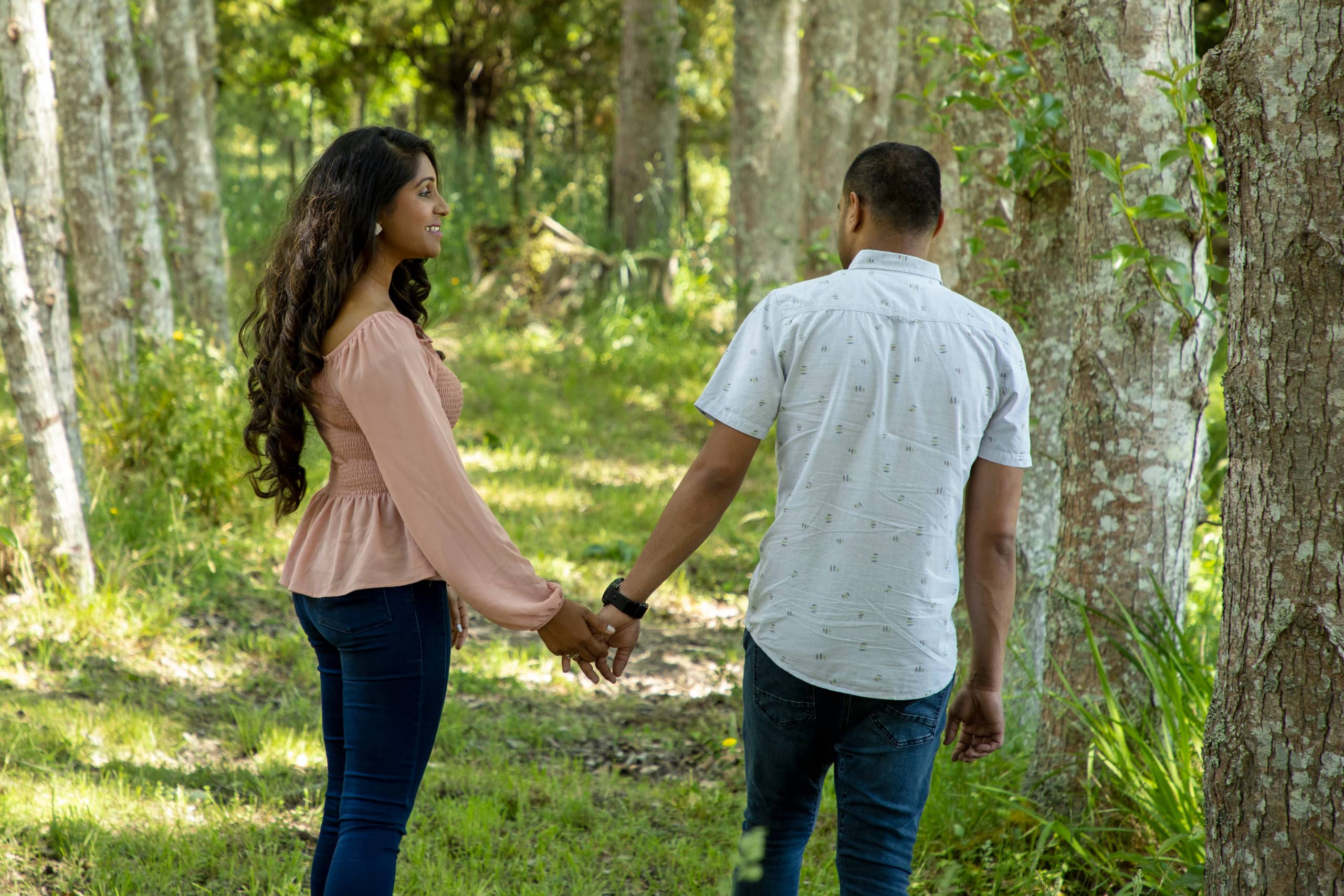 couple holding hands walking outside
