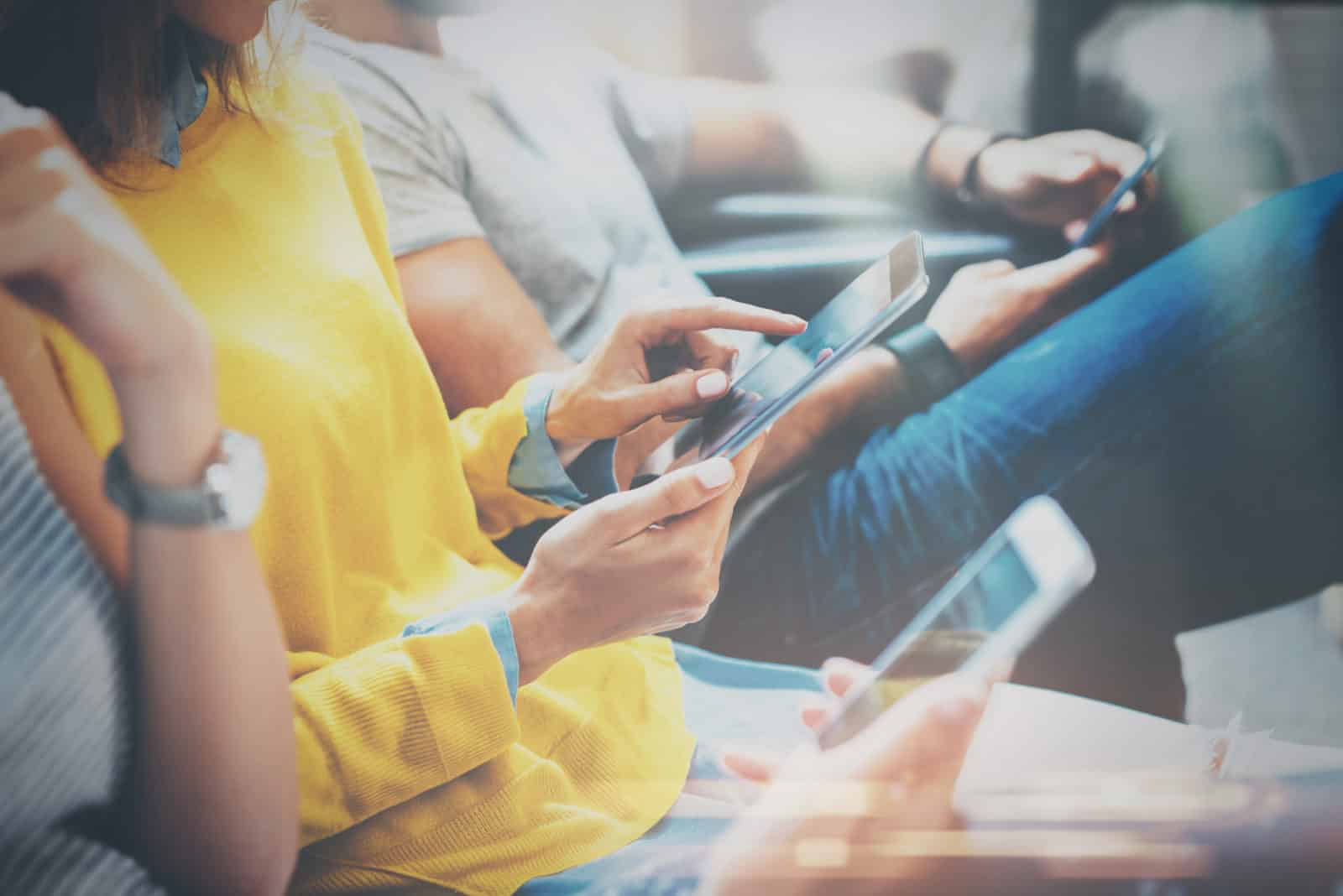 Group Of Young Adults holding phones