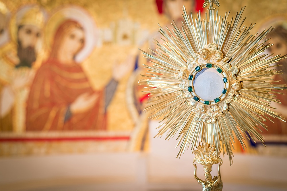 Adoration monstrance with the Blessed Sacrament on the altar,